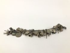 SILVER CHARM BRACELET TO INCLUDE APPROX 38 CHARMS MAINLY SILVER.