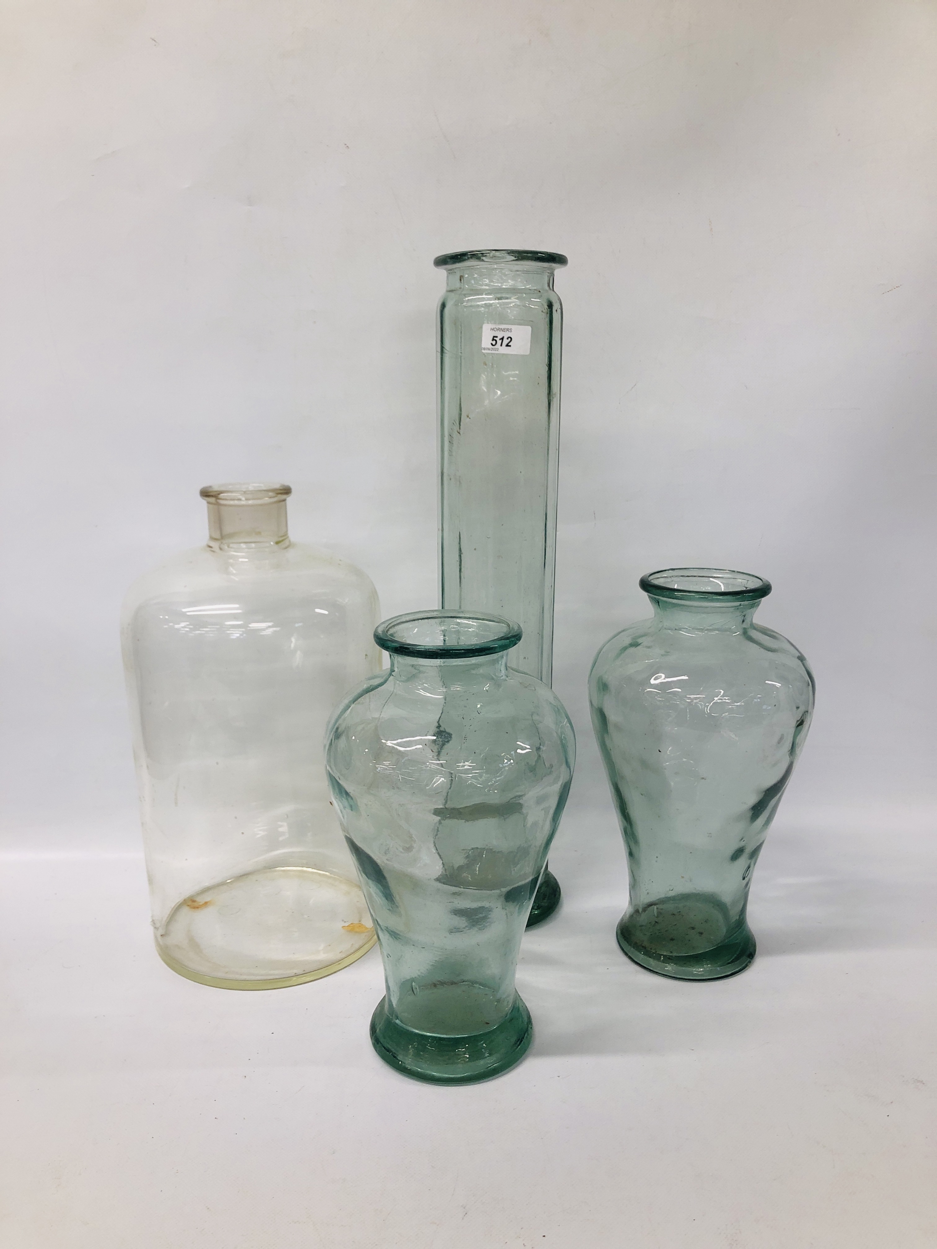 TWO GLASS VASES, A TALL CYLINDER VASE AND ONE OTHER GLASS BOTTLE.