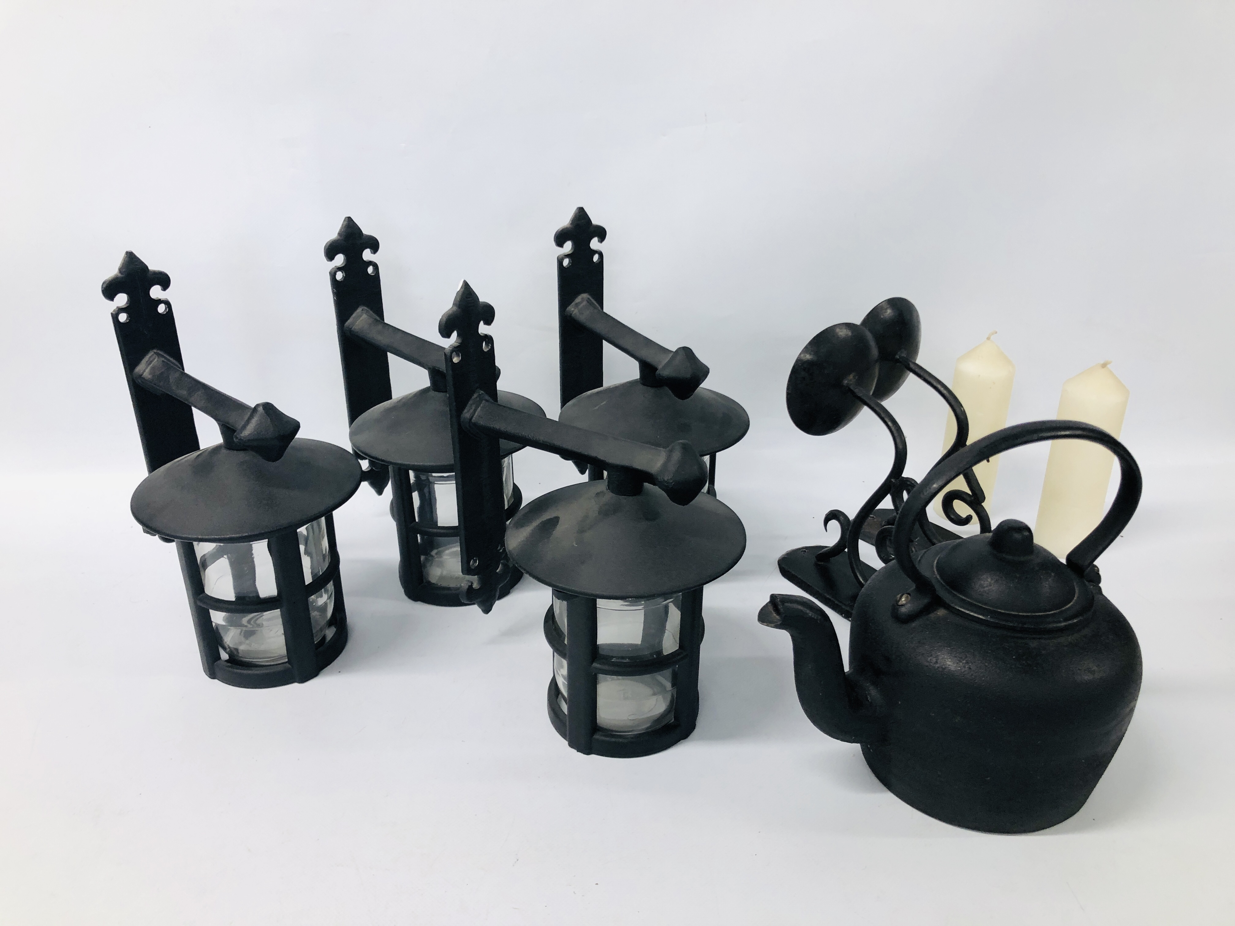 A SET OF FOUR CAST WALL LAMPS ALONG WITH TWO WALL MOUNTED CANDLESTICK HOLDERS AND CAST IRON KETTLE