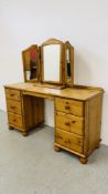 A GOOD QUALITY HONEY PINE SIX DRAWER DRESSING TABLE WITH TRIPLE DRESSING MIRROR WIDTH 143CM.