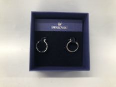 A PAIR OF BOXED SWAROVSKI PE HOOP EARRINGS.