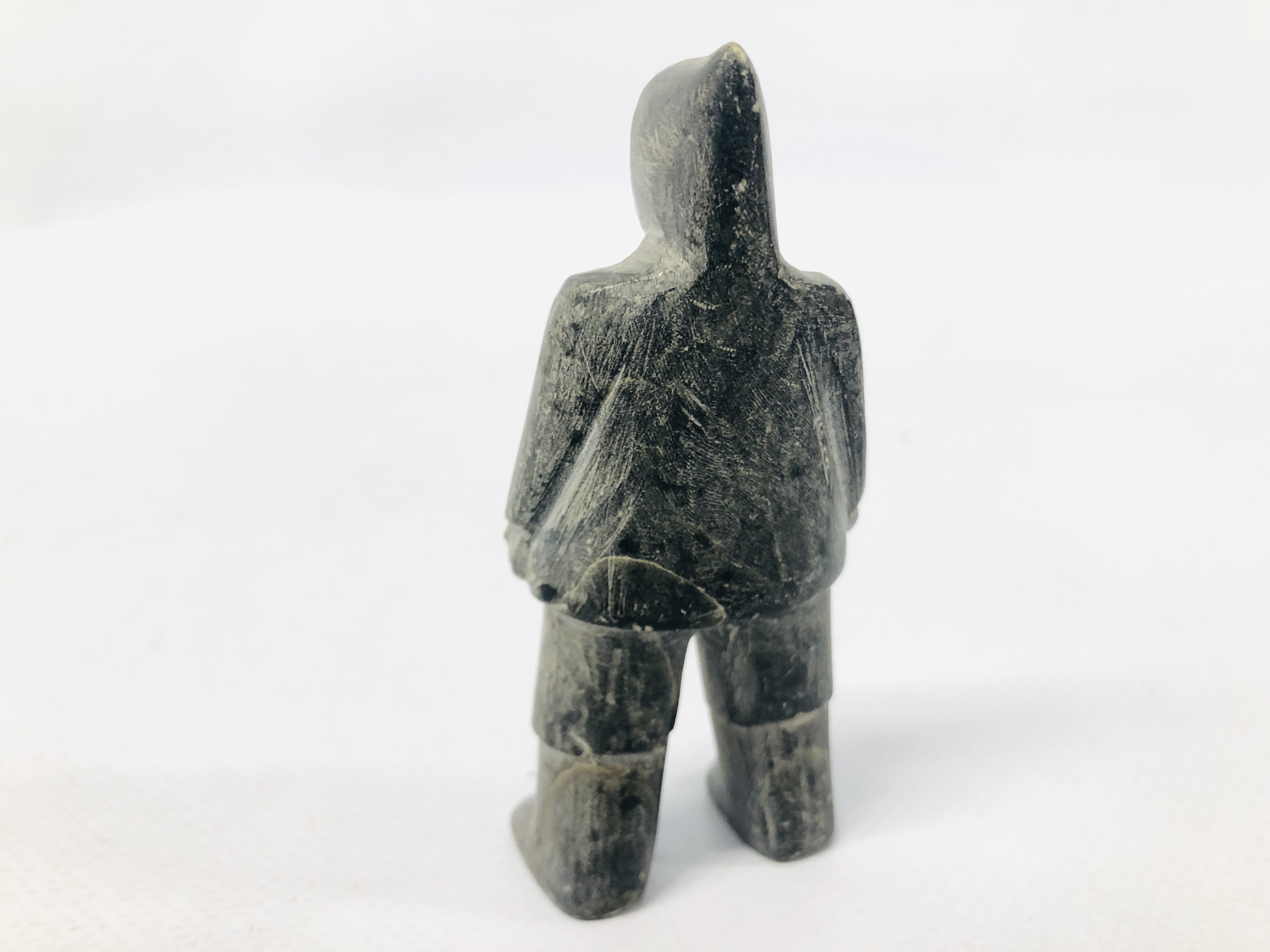 A CANADIAN CARVED SOAPSTONE OF AN INUIT FIGURE. - Image 4 of 6