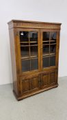 A GOOD QUALITY REPRODUCTION OAK TWO DOOR GLAZED DISPLAY CABINET ON TWO DOOR CUPBOARD BASE W 97CM,