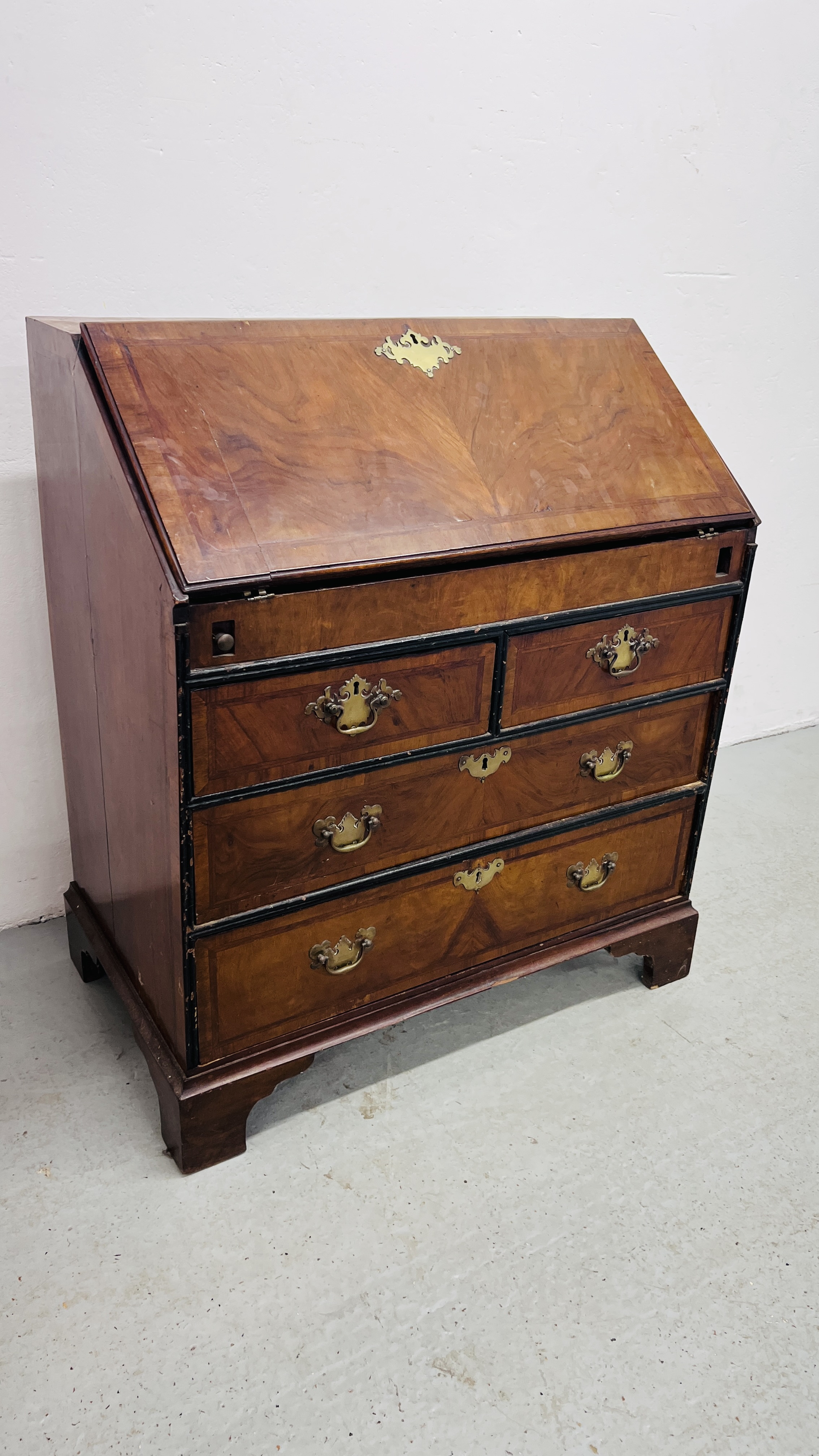 A GEORGE II WALNUT BUREAU, FALLING FRONT ENCLOSING FITTED INTERIOR WITH WELL,