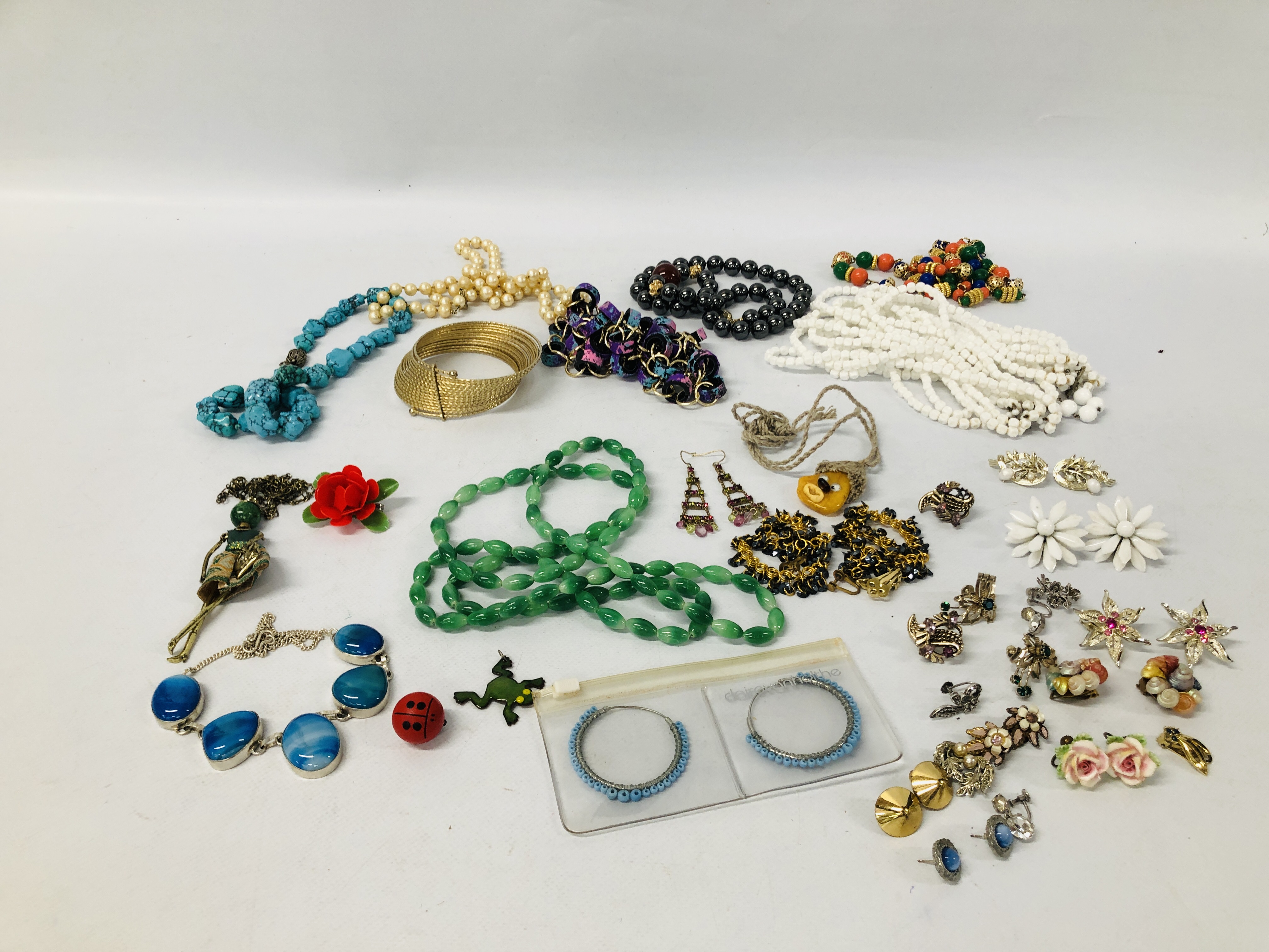 TWO BOXES OF ASSORTED COSTUME JEWELLERY INCLUDING BEADS AND PENDANTS, EARRINGS ETC.