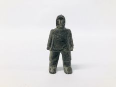 A CANADIAN CARVED SOAPSTONE OF AN INUIT FIGURE.