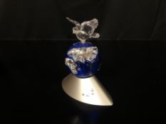 A BOXED SWAROVSKI MILLENNIUM CRYSTAL DOVE OF PEACE FIGURE ON EARTH.