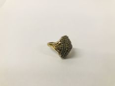 AN ART DECO STYLE DIAMOND CLUSTER RING OF RAISED FORM IN 9CT. GOLD SETTING.