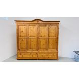A GOOD QUALITY HONEY PINE FOUR DOOR WARDROBE WITH TWO DRAWER BASE WIDTH 228CM. DEPTH 59CM.