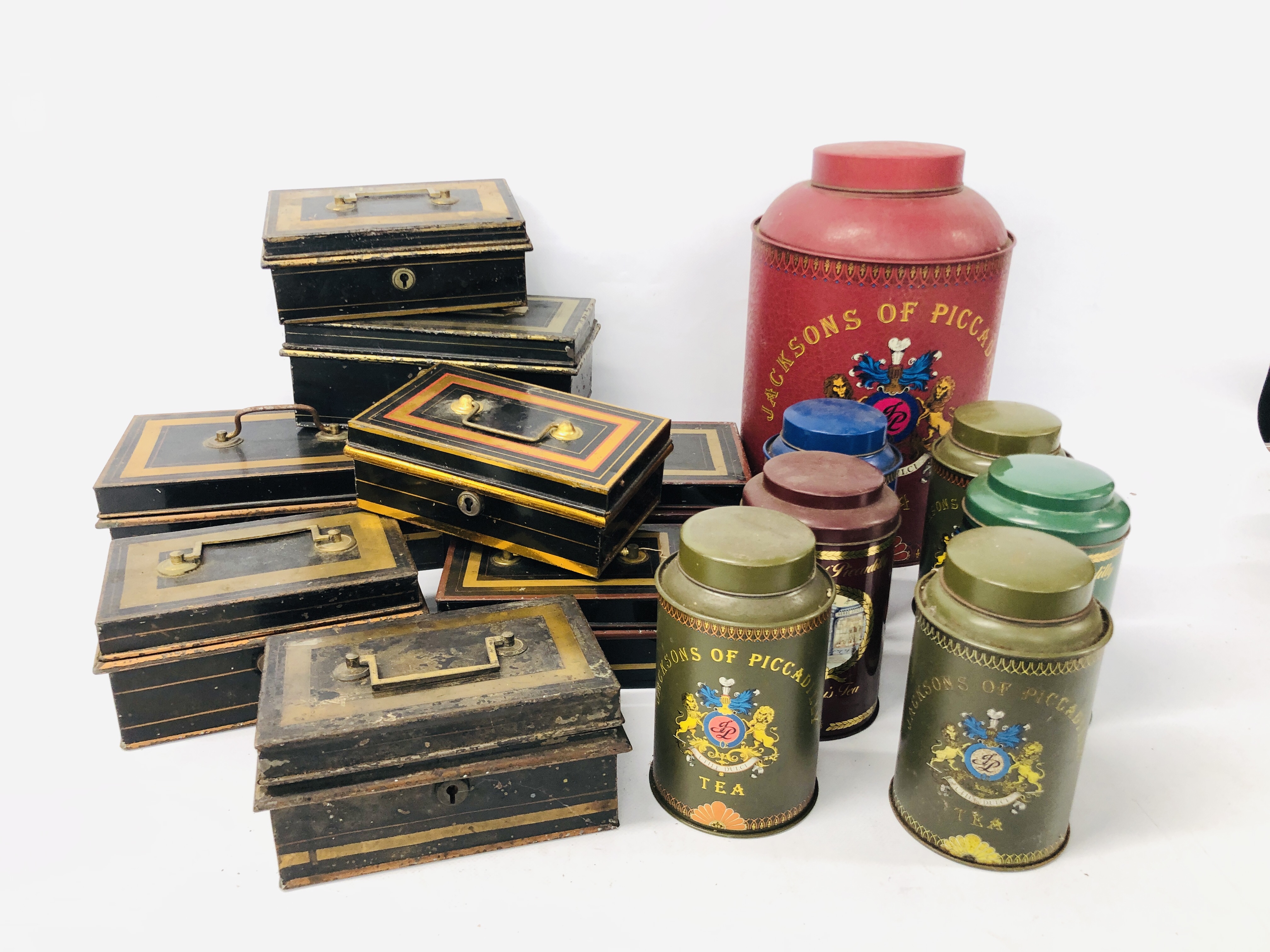 7 JACKSONS OF PICCADILLY TEA TINS ALONG WITH 8 VINTAGE BLACK AND GOLD TONE CASH TINS