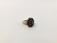 A 9CT. GOLD AMETHYST CLUSTER RING.