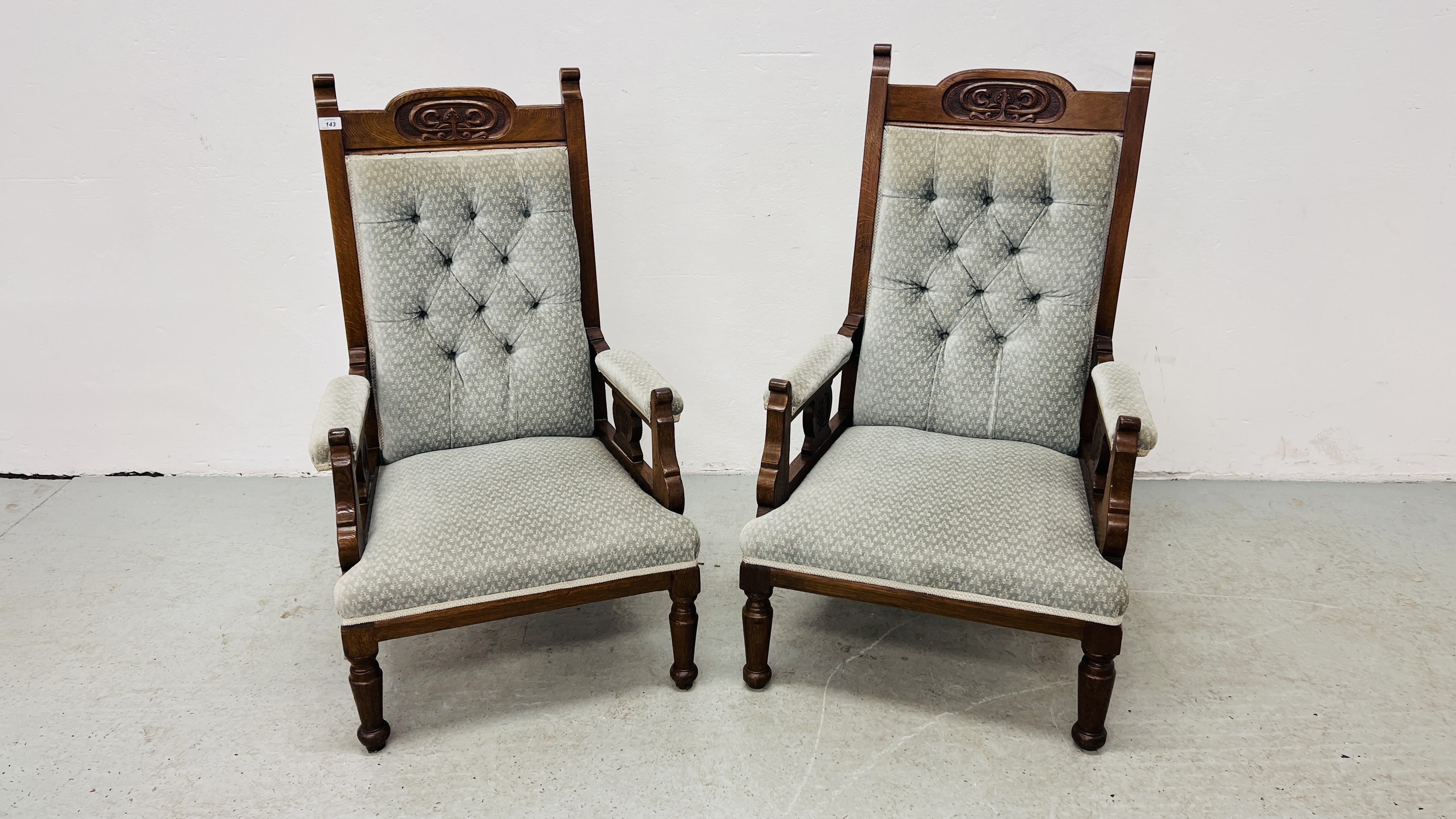 A PAIR OF EDWARDIAN OAK LOW SEAT CHAIRS UPHOLSTERED IN PASTEL BLUE