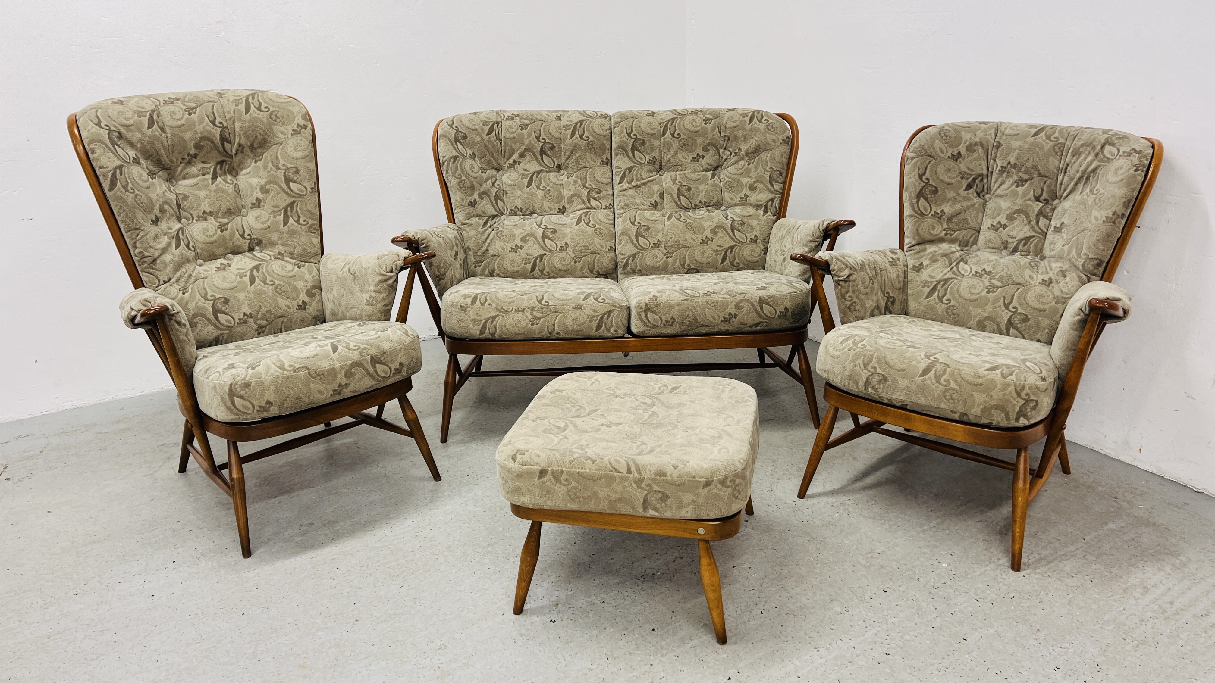 AN ERCOL "GOLDEN DAWN" FINISH COTTAGE THREE PIECE LOUNGE SUITE WITH MATCHING FOOTSTOOL - TRADE ONLY.