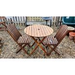 A WOODEN CIRCULAR GARDEN BISTRO TABLE AND TWO FOLDING CHAIRS