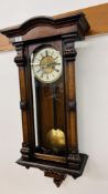 AN ANTIQUE STRIKING WALL HANGING CASED CLOCK WITH FLORAL DETAIL.