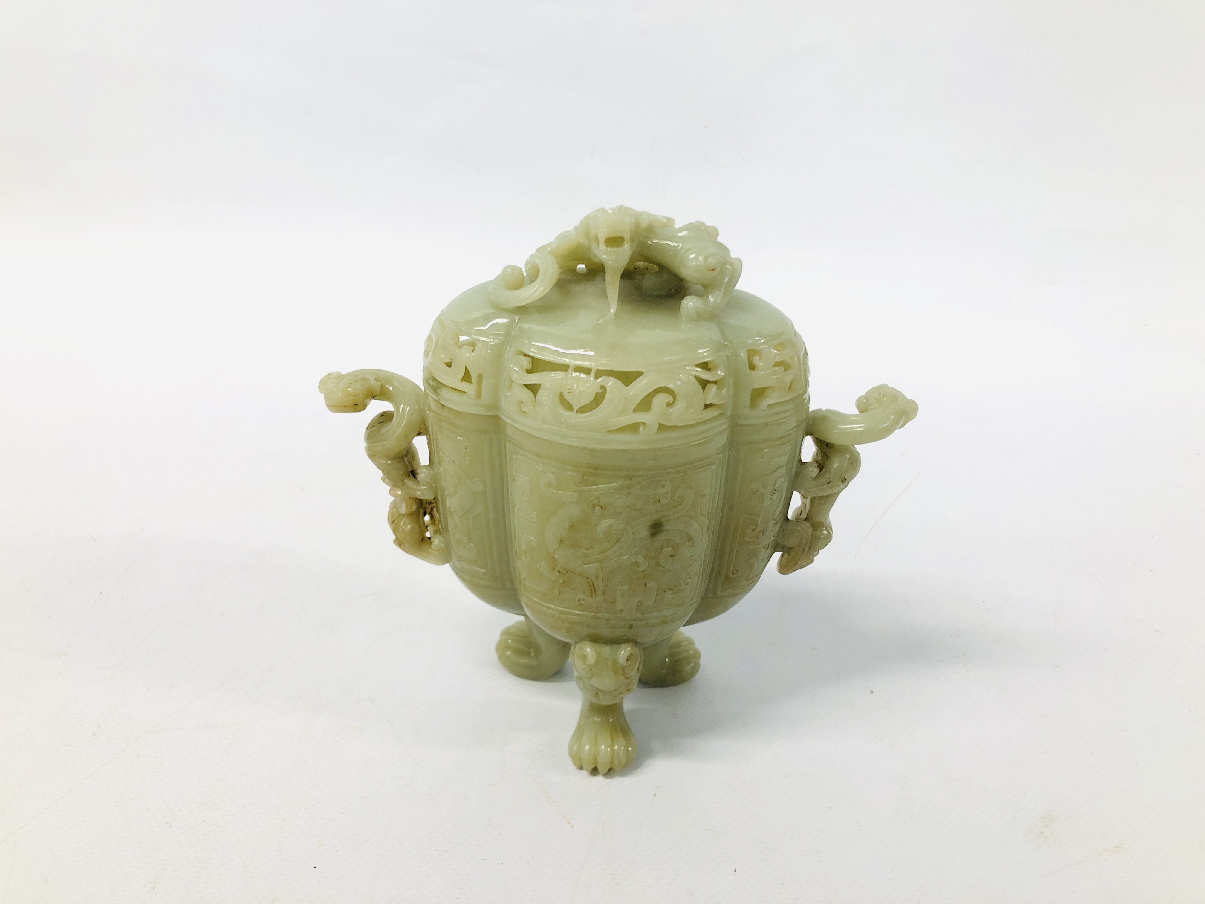 WELL CARVED CHINESE CELADON JADE JAR AND COVER OF ARCHAIC FORM ON THREE MASK AND PAW FEET,