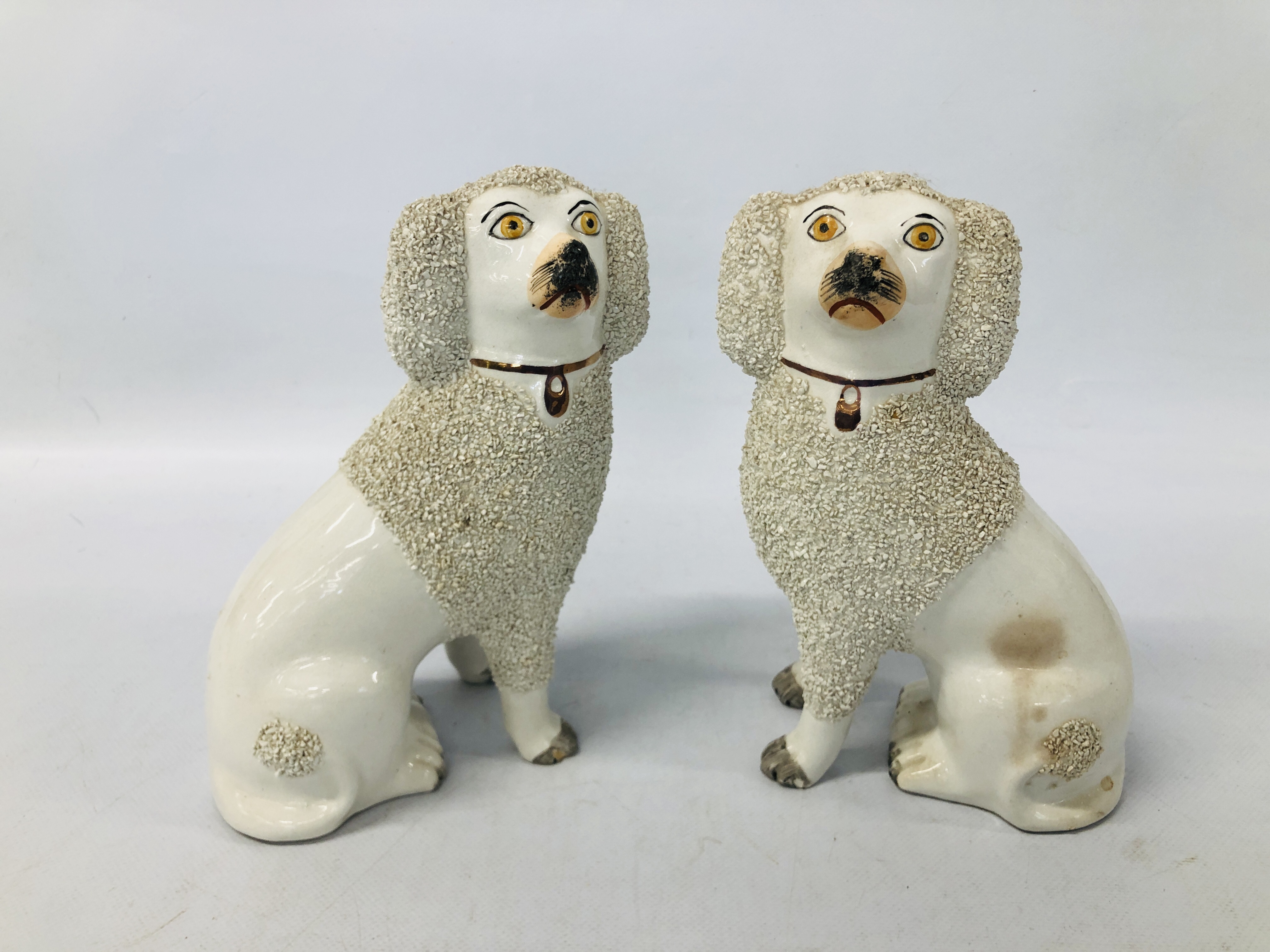A PAIR OF C19TH STAFFORDSHIRE DOGS H 23.5CM.
