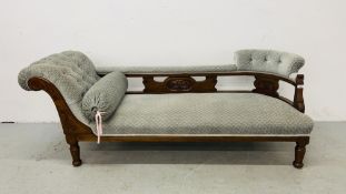 AN EDWARDIAN OAK CHAISE LONGUE UPHOLSTERED IN PASTEL BLUE