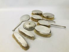 A PAIR OF SILVER BACKED CLOTHES BRUSHES MONOGRAMMED HJA,