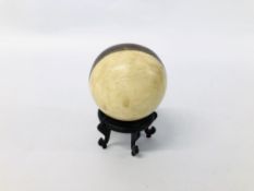 A HARDSTONE SPHERE WITH CENTRAL BAND DIAM. 8.5CM.