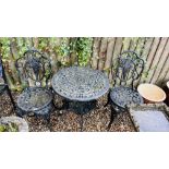 A DECORATIVE CAST METAL GARDEN TABLE AND TWO GARDEN CHAIRS.