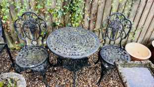 A DECORATIVE CAST METAL GARDEN TABLE AND TWO GARDEN CHAIRS.