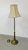 A HEAVY BRASS STANDARD LAMP WITH SHADE - SOLD AS SEEN.