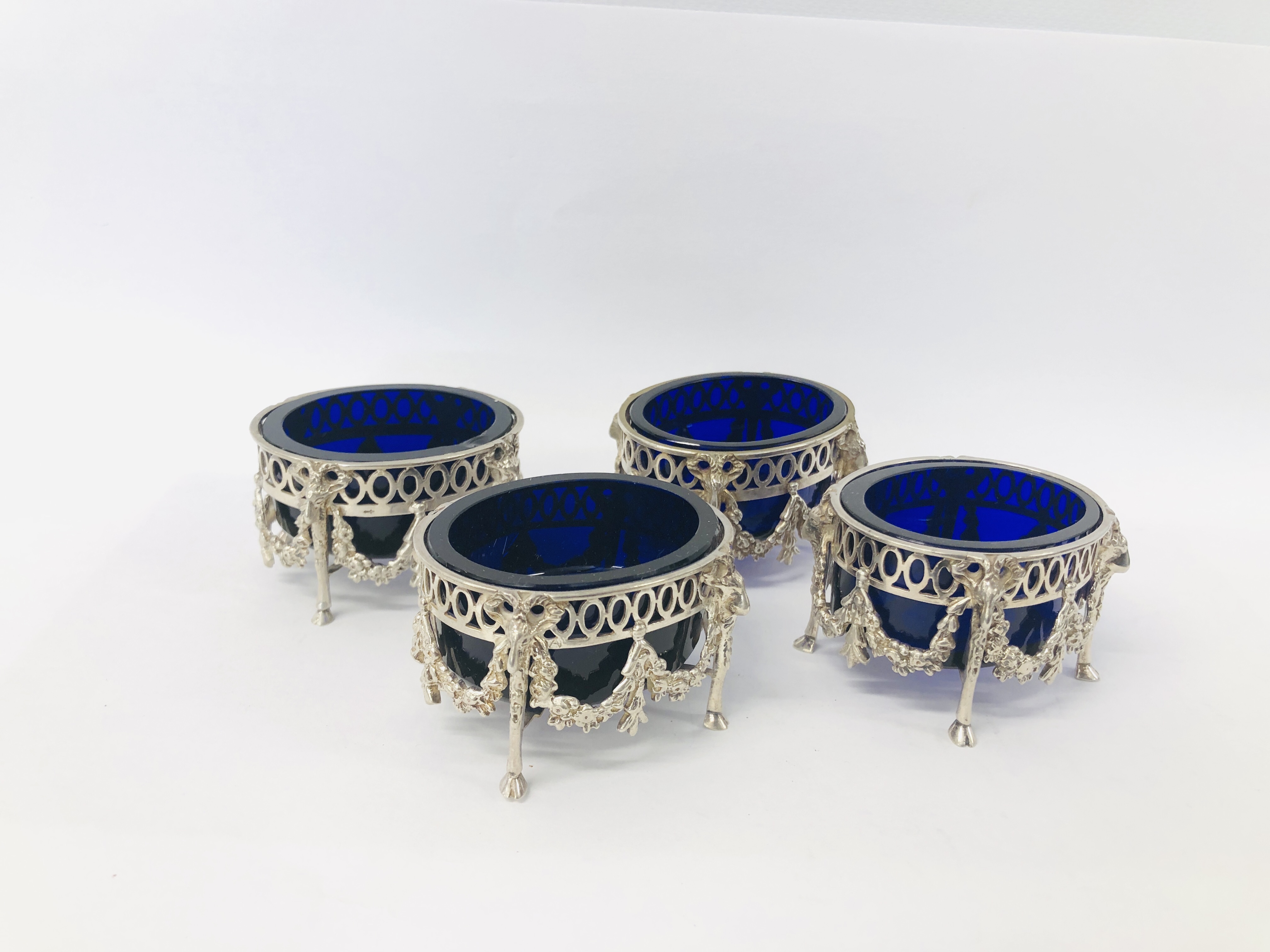 FOUR DUTCH SILVER SALTS WITH BLUE GLASS LINERS (ONE LINER A/F)