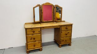 A GOOD QUALITY HONEY PINE SIX DRAWER DRESSING TABLE WITH TRIPLE DRESSING MIRROR WIDTH 143CM.