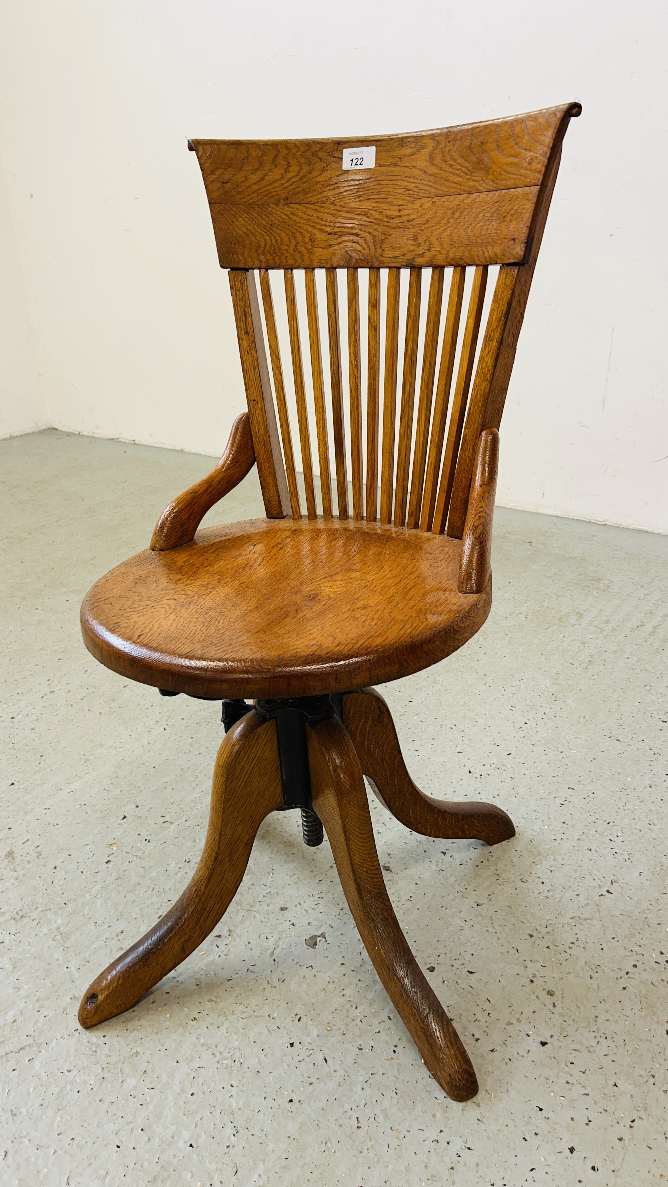 ANTIQUE OAK REVOLVING STICK BACK OFFICE CHAIR.