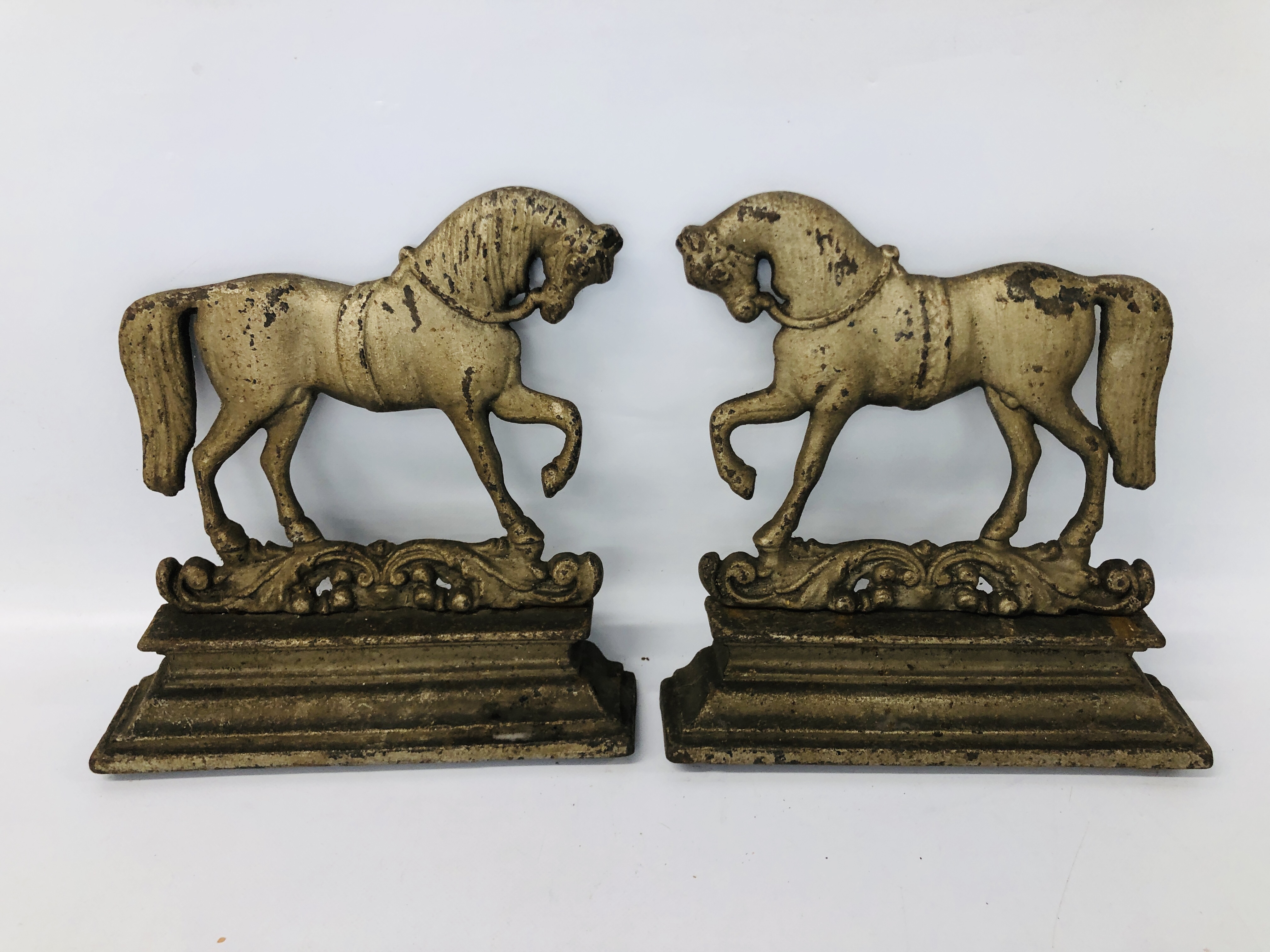 A PAIR OF CAST IRON HORSE FIRE GUARDS