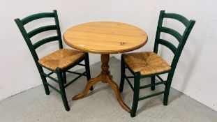 A CIRCULAR TOP PINE PEDESTAL BREAKFAST TABLE DIAMETER 74CM AND TWO RUSH SEATED DINING CHAIRS.