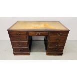 A REPRODUCTION OAK LEATHER TOP TWIN PEDESTAL DESK WITH NINE DRAWERS AND BRASS HANDLES 78CM. X 136CM.