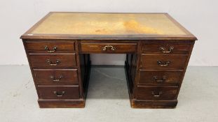 A REPRODUCTION OAK LEATHER TOP TWIN PEDESTAL DESK WITH NINE DRAWERS AND BRASS HANDLES 78CM. X 136CM.