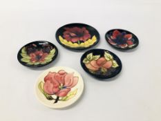 FOUR MOORCROFT PIN DISHES OF VARIOUS DESIGNS (DIA. 12CM.) AND ONE LARGER (DIA. 15.5CM.