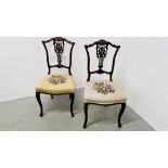 A PAIR OF ORNATE MAHOGANY SIDE CHAIRS WITH EMBROIDERED STUFF OVER SEATS.