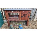 A HANDMADE TWO TIER ANIMAL HUTCH WITH BULL FACE STENCIL.