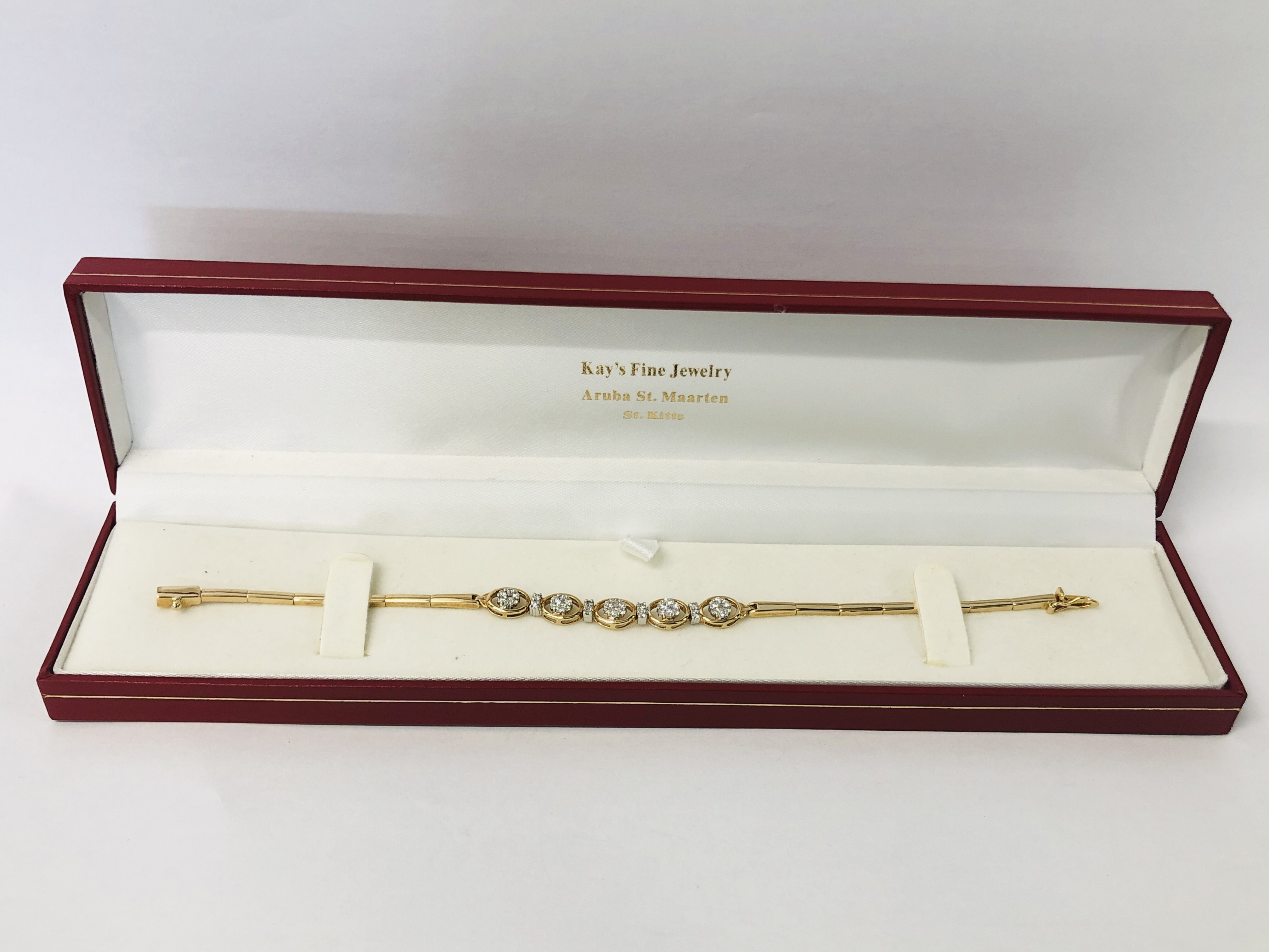 A MODERN BRACELET MARKED 585 SET WITH FORTY THREE SMALL DIAMONDS IN FLOWER HEAD SETTING ACCOMPANIED