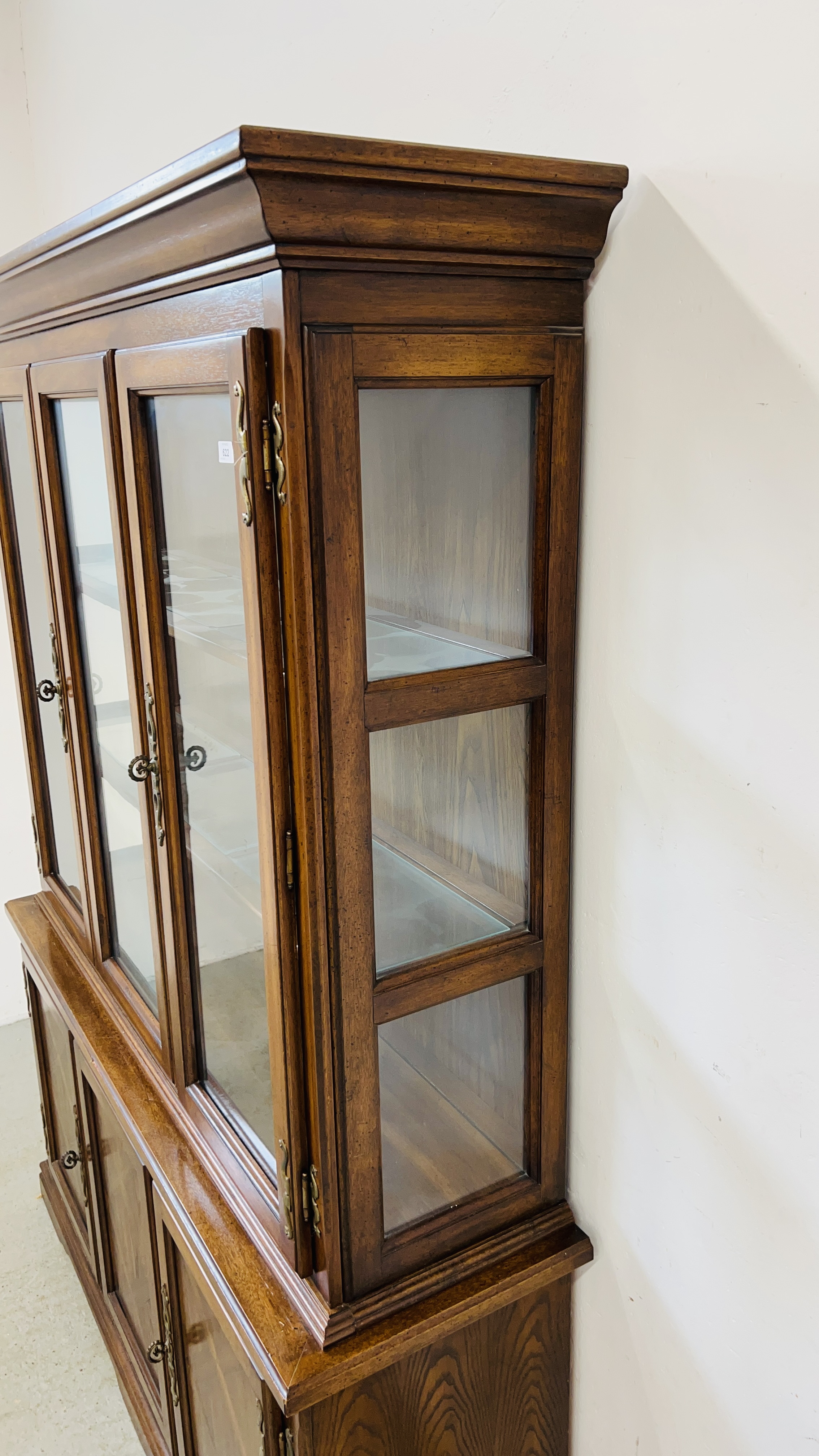 A REPRODUCTION ANTIQUE FINISH DISPLAY CABINET WITH THREE DOOR CABINET BASE W 149CM, D 43CM, H 202CM. - Image 9 of 9