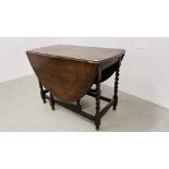 A SOLID OAK OVAL TOP GATELEG DNING TABLE WITH BARLEY TWIST LEGS - W 106CM. D 56CM.