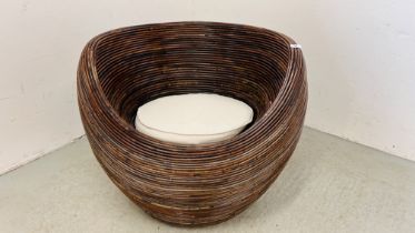 A LARGE DESIGNER WICKER TUB CHAIR WITH CUSHIONED SEAT - W 85CM.