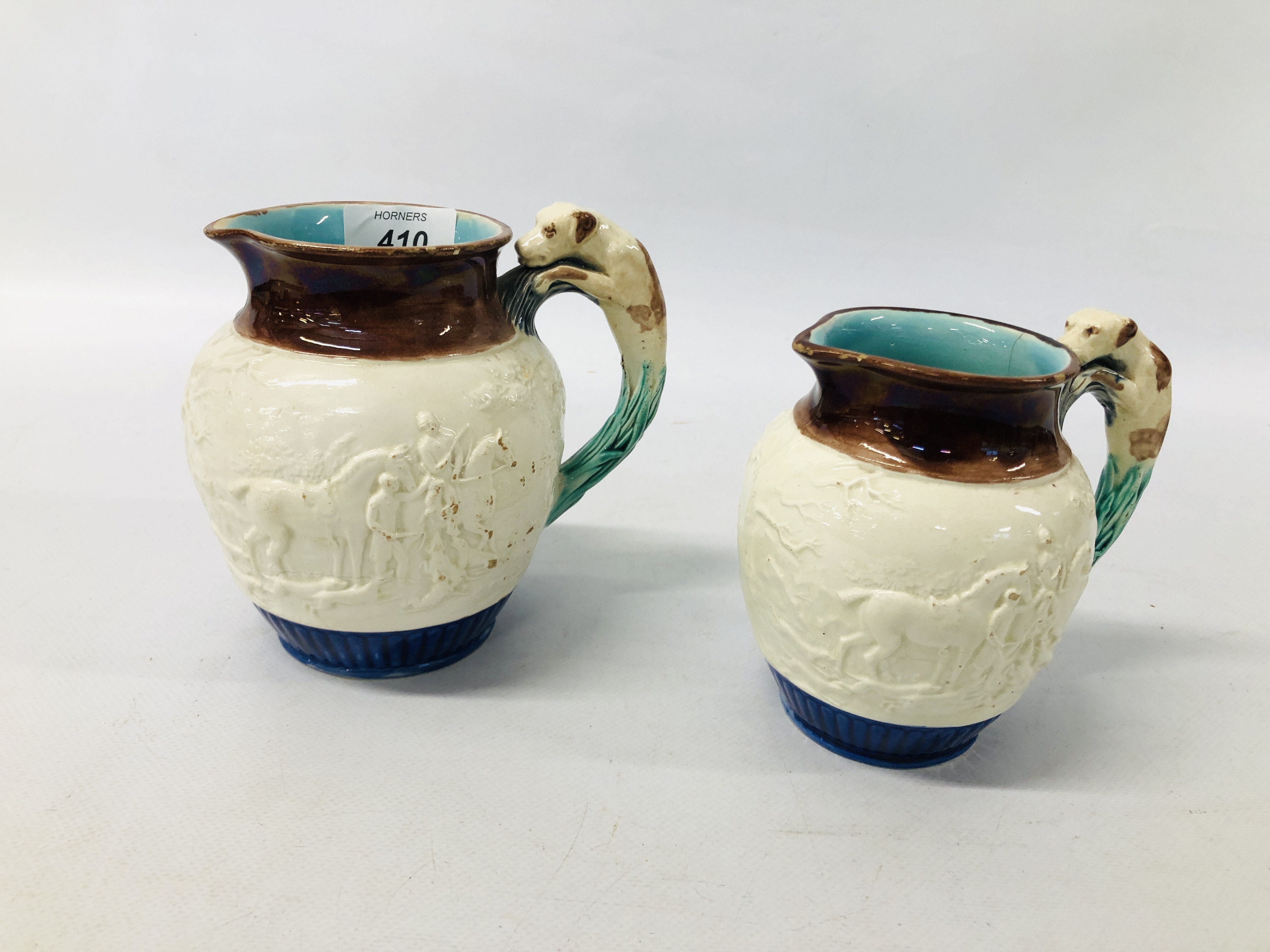 TWO VINTAGE WEDGWOOD GRADUATED STONEWARE GLAZED HUNTING JUGS (A/F)