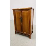 A SMALL ORIENTAL HARDWOOD TWO DOOR CABINET, THE DOORS CONCEALING TEN INTERIOR DRAWERS - W 57CM.