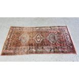 PERSIAN RUG, THE THREE CENTRAL LOZENGES ON A RED FIELD - L 210CM X W 105CM.