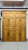 AN IMPRESSIVE OVERSIZE EIGHT DOOR WAXED PINE LARDER CUPBOARD WITH SHELVED INTERIOR (TWO SECTIONS) -