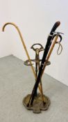 A VINTAGE BRASS ACANTHUS UMBRELLA STAND ALONG WITH 4 WALKING STICKS TO INCLUDE SILVER BANDED ALONG