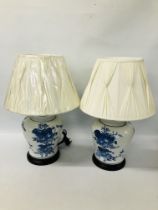 PAIR OF LARGE BLUE AND WHITE TABLE LAMPS WITH CREAM PLEATED SHADES - SOLD AS SEEN.