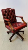 A REPRODUCTION RED LEATHER BUTTON BACK REVOLVING OFFICE CHAIR