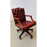 A REPRODUCTION RED LEATHER BUTTON BACK REVOLVING OFFICE CHAIR