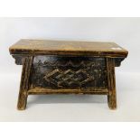 A SMALL CHINESE CARVED ELM WOOD TWO DRAWER STOOL OF SPLAYED DESIGN, DRAWERS TO EITHER END.